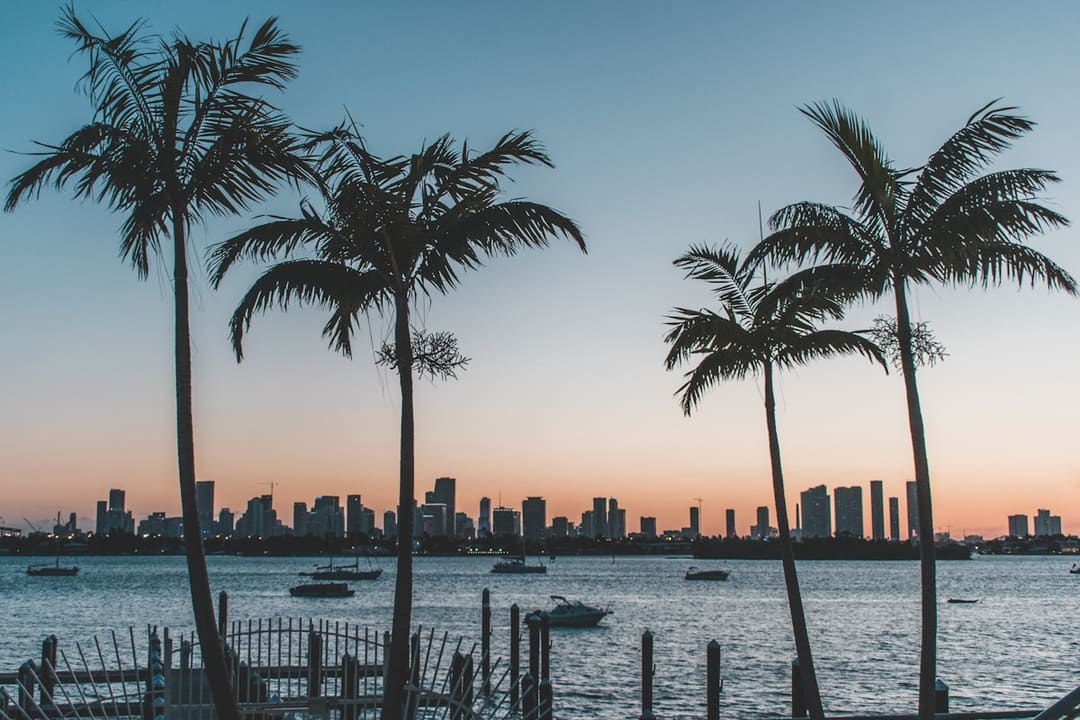 "Miami Brickell financial district skyline at dusk seen across Biscayne Bay."