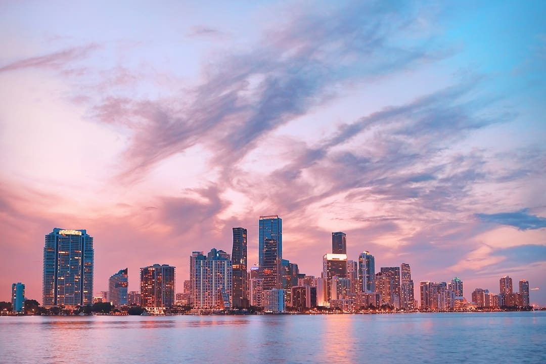"Miami Brickell skyline of glass high-rise towers seen at dusk."
